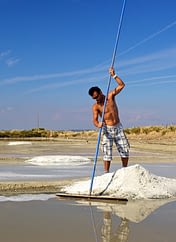 Camping Sainte Brigitte - Loire Atlantique - Paludier qui récolte le gros sel dans les marais salants de Guérande