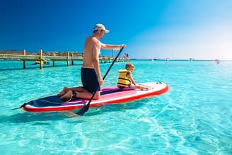 Domaine de Bagheera, Esperienza, un padre e suo figlio che si divertono con il paddle sulla spiaggia di Santa Giulia, in Corsica