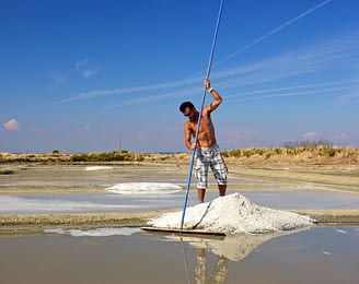 Camping Sainte Brigitte - Loire Atlantique - Paludier qui récolte le gros sel dans les marais salants de Guérande