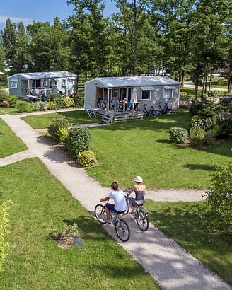 Parc du Val de Loire Campsite - Activities and Entertainment - Couple bike-riding through the paths of the campsite