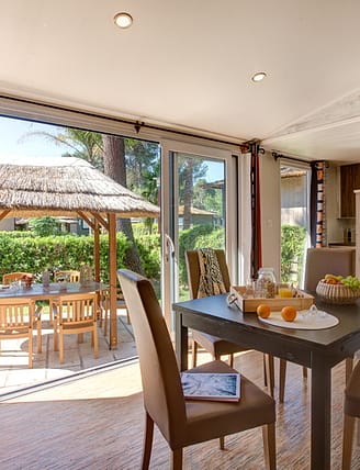 Camping Le Brasilia, Cottage Okavango, séjour et vue sur la terrasse
