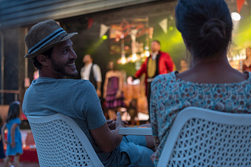 Le Brasilia campsite, activities and evening events, couple watching a show in the Agora
