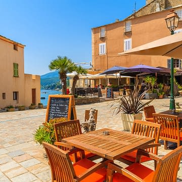 Domaine de Bagheera, Expérience, Tables d'un restaurant situé dans la vieille ville d'Erbalunga, sur la côte corse.