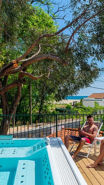 Le Bois de Valmarie campsite - Wellness area - Couple seated on the terrace of the Jacuzzi