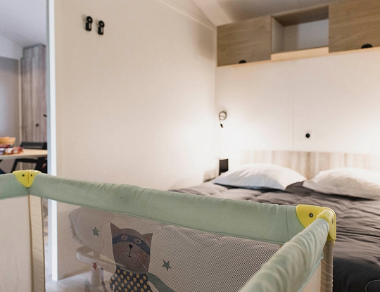 Camping Zelaia - Mobil-home superior para 4 personas - Dormitorio con una cama doble grande y una cuna